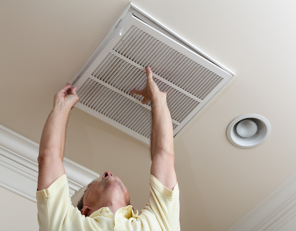 A person checking an air filter